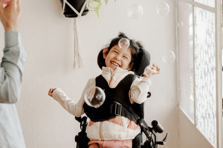 disabled child having fun with bubbles